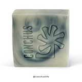 Tide natural body wash bar with blue clay and indigo swirl, embossed CONCHUS logo, handmade vegan soap